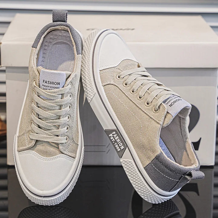 Side view of women's blue canvas trainers with textured sole and pull tab