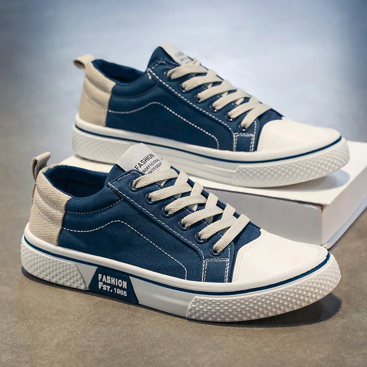 Detail of women's canvas trainers featuring contrast stitching and heel pull tab