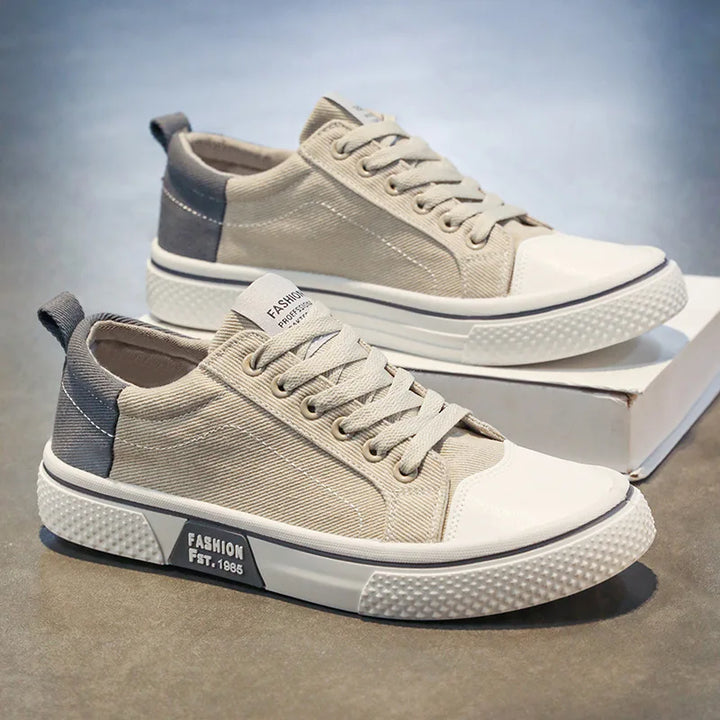 Women's lace-up canvas trainers showing low-top design and cushioned insole construction