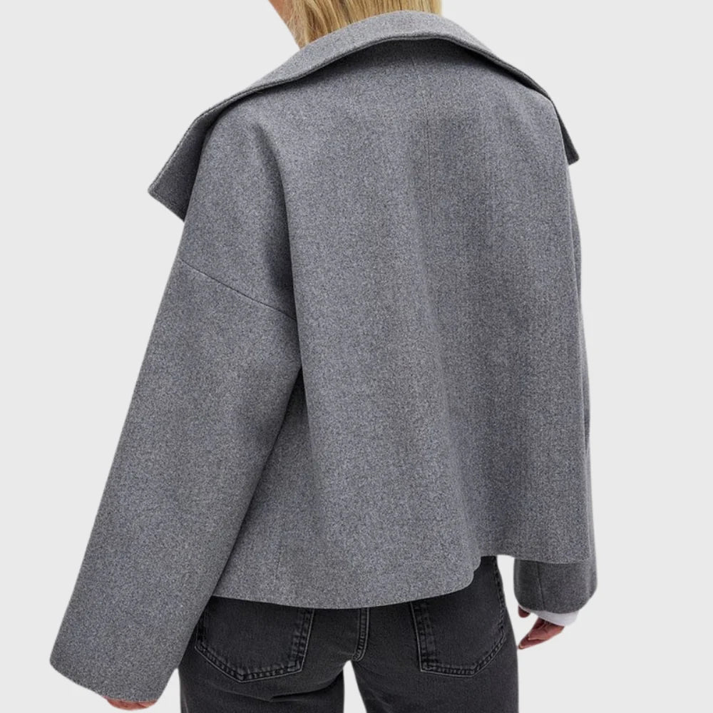 Women's black cropped coat showing contemporary styling and clean lines throughout