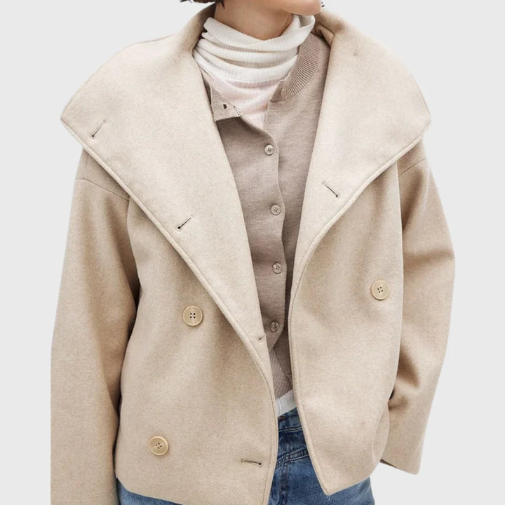 Side view of cropped coat with long sleeves and textured woven fabric finish