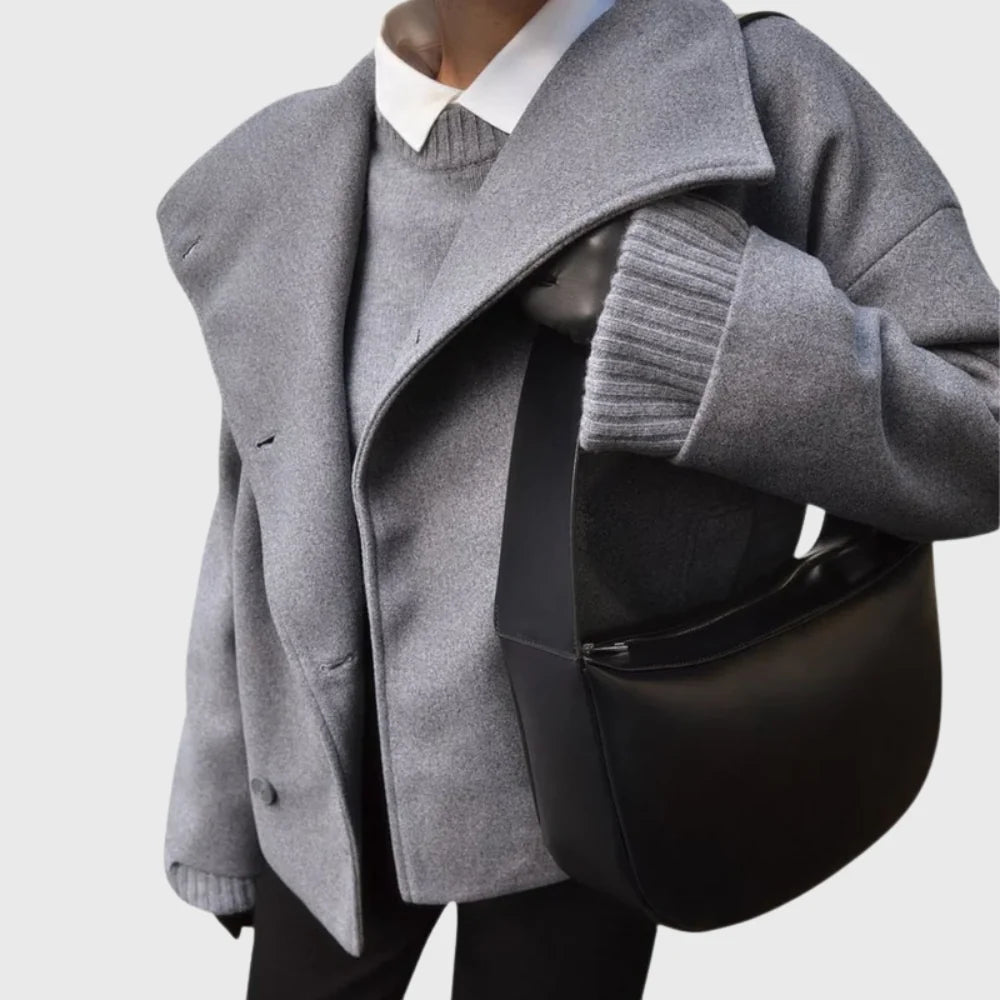 Women's black cropped coat styled over ribbed knitwear and dark trousers
