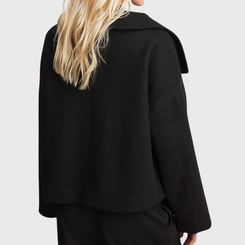 Detail of double breasted button closure on women's tailored cropped coat