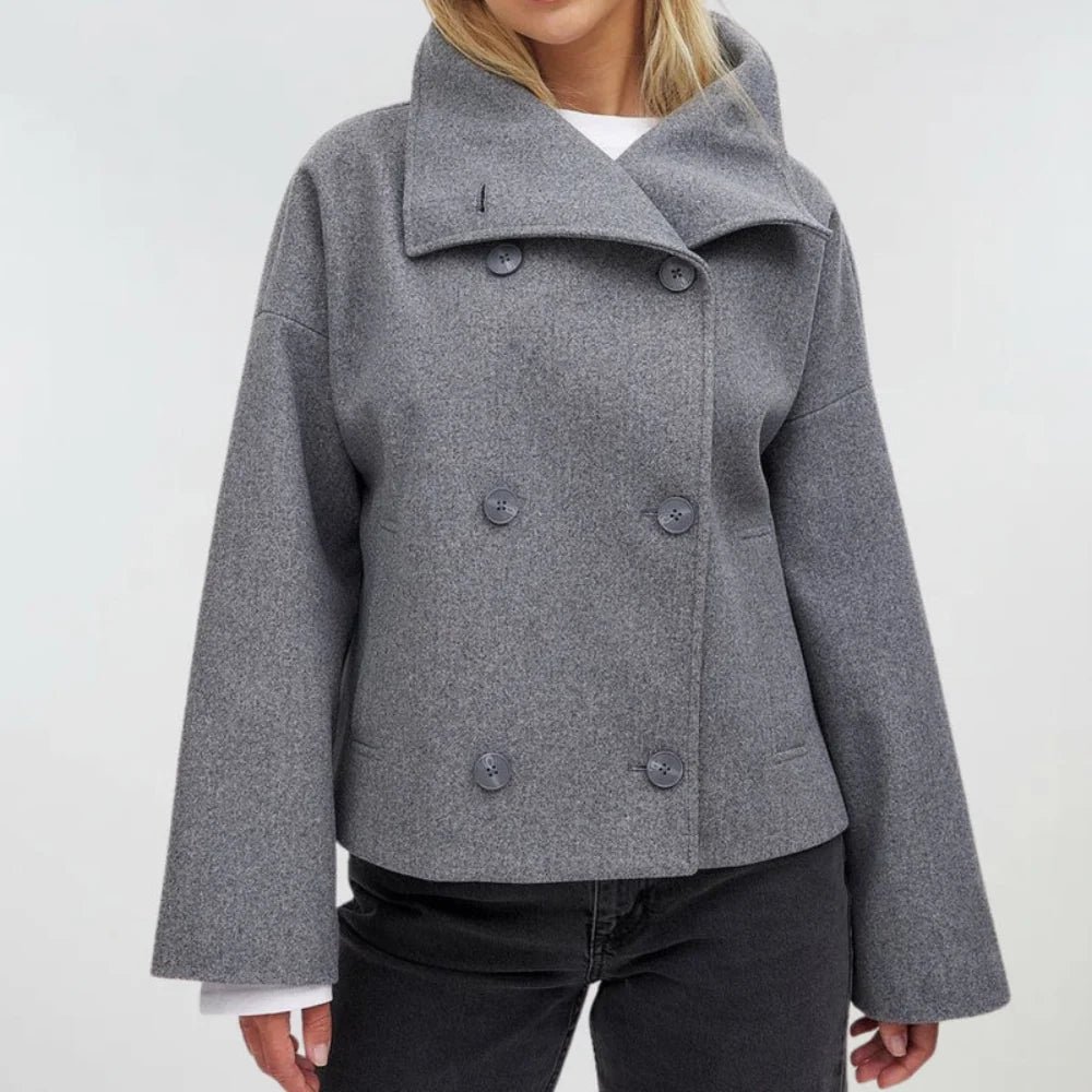 Close-up of textured fabric and tailored construction on women's double breasted coat