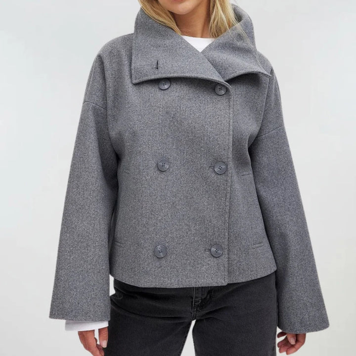 Close-up of textured fabric and tailored construction on women's double breasted coat
