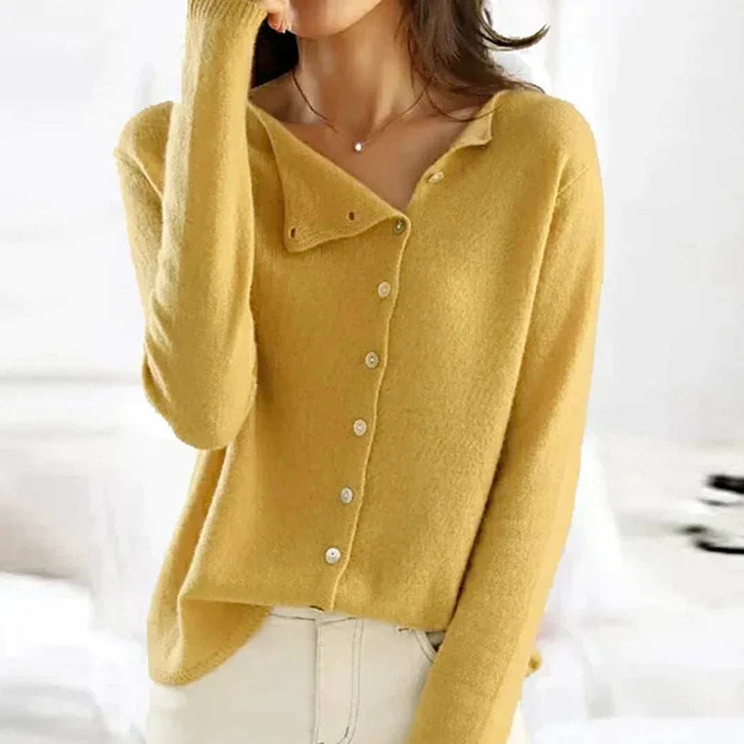 Women's asymmetric button cardigan styled with tailored trousers for smart casual office wear