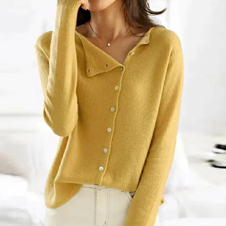 Women's asymmetric button cardigan styled with tailored trousers for smart casual office wear