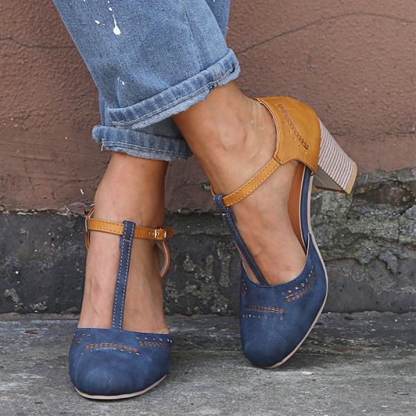 Women's T-bar block heel shoes in navy and tan with ankle strap worn with rolled denim jeans