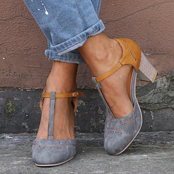 Close-up of women's vintage-inspired T-bar heels showing perforated toe detail and chunky block heel
