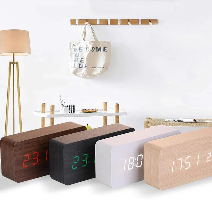 Digital wooden alarm clock showing LED display with time date and temperature readings