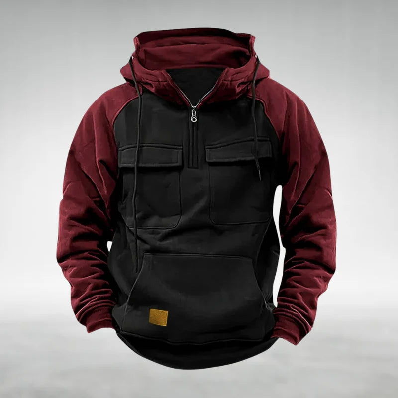 Close-up of chest flap pockets and quarter-zip hardware on men's fleece hoodie
