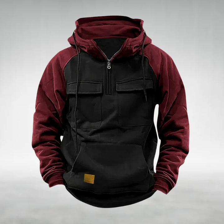 Close-up of chest flap pockets and quarter-zip hardware on men's fleece hoodie