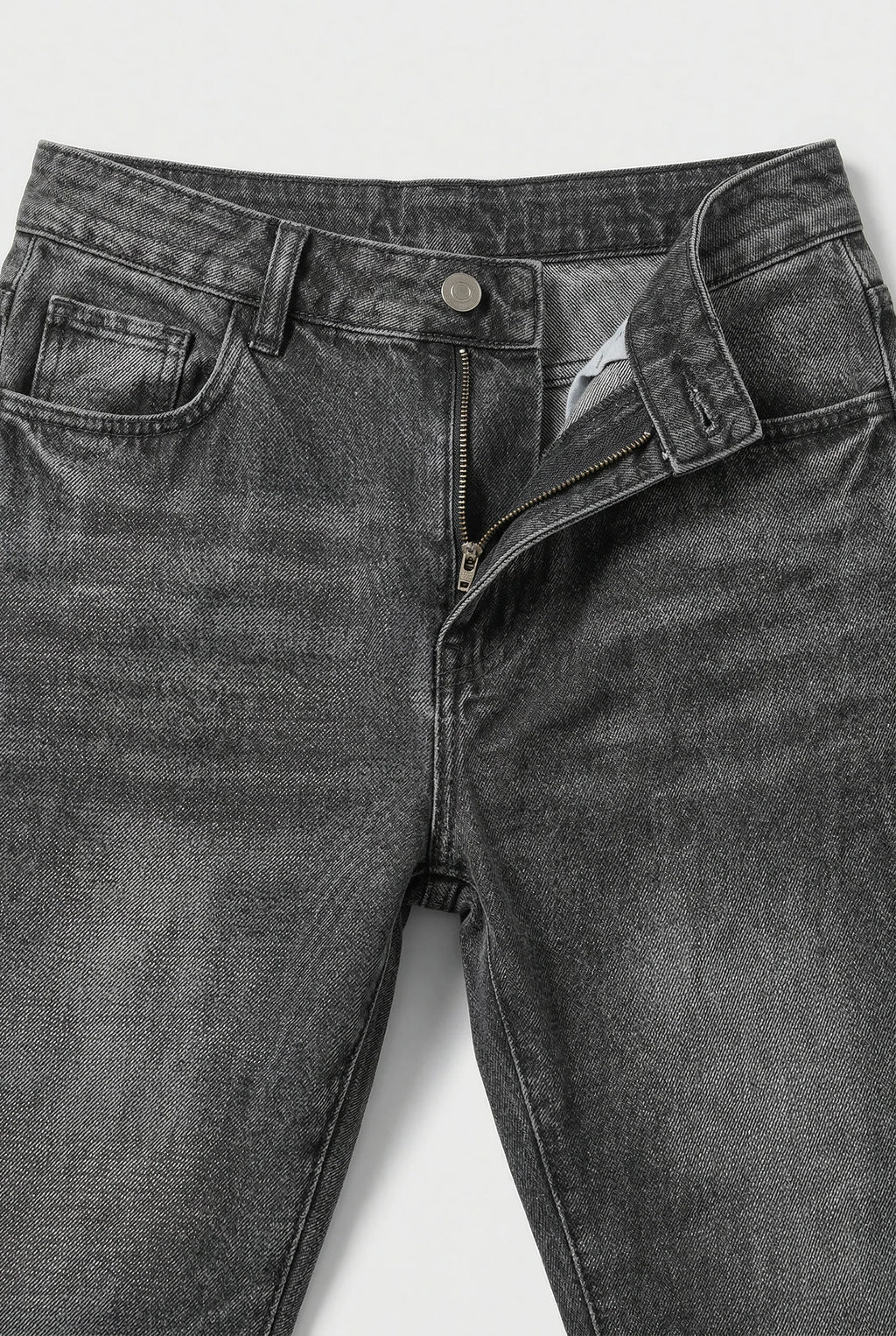 Close-up of men's loose fit jeans waistband with button closure and belt loops
