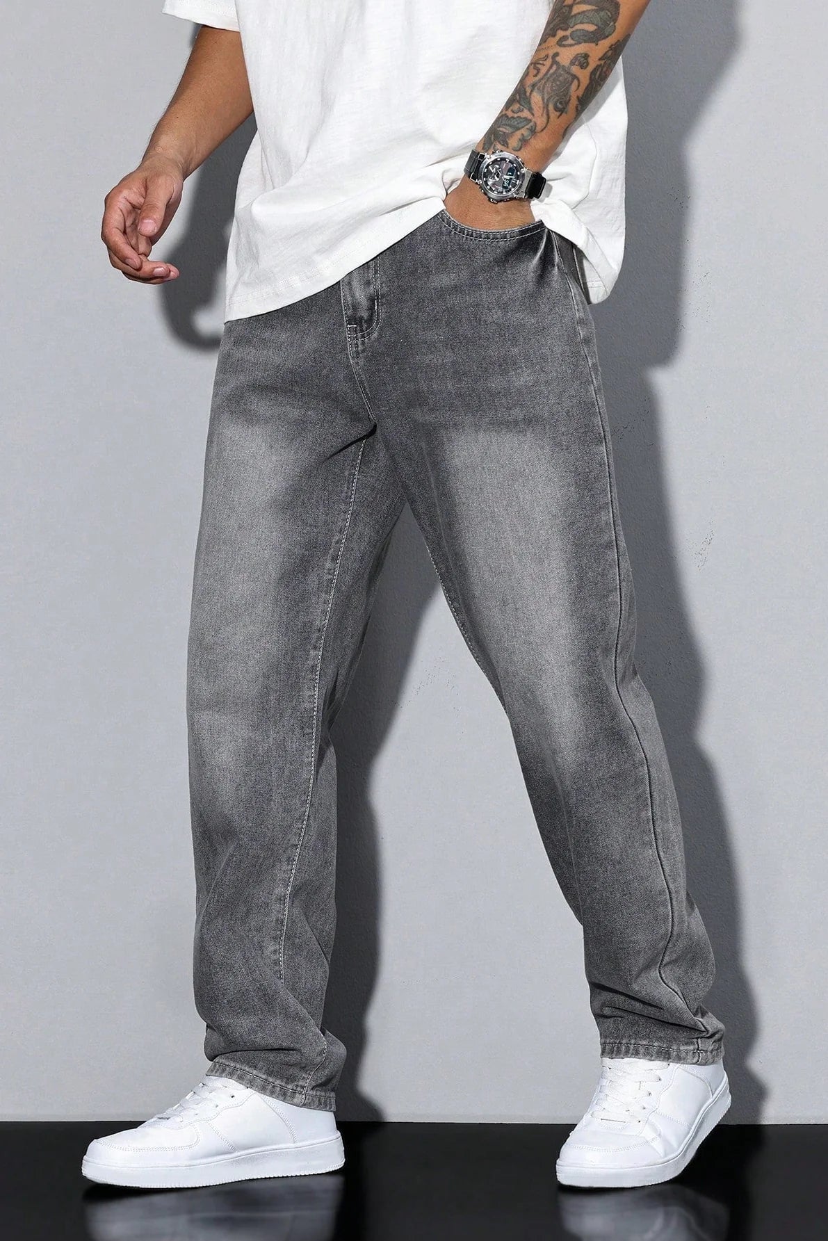 Detail of men's jeans pocket construction and washed grey denim fabric texture