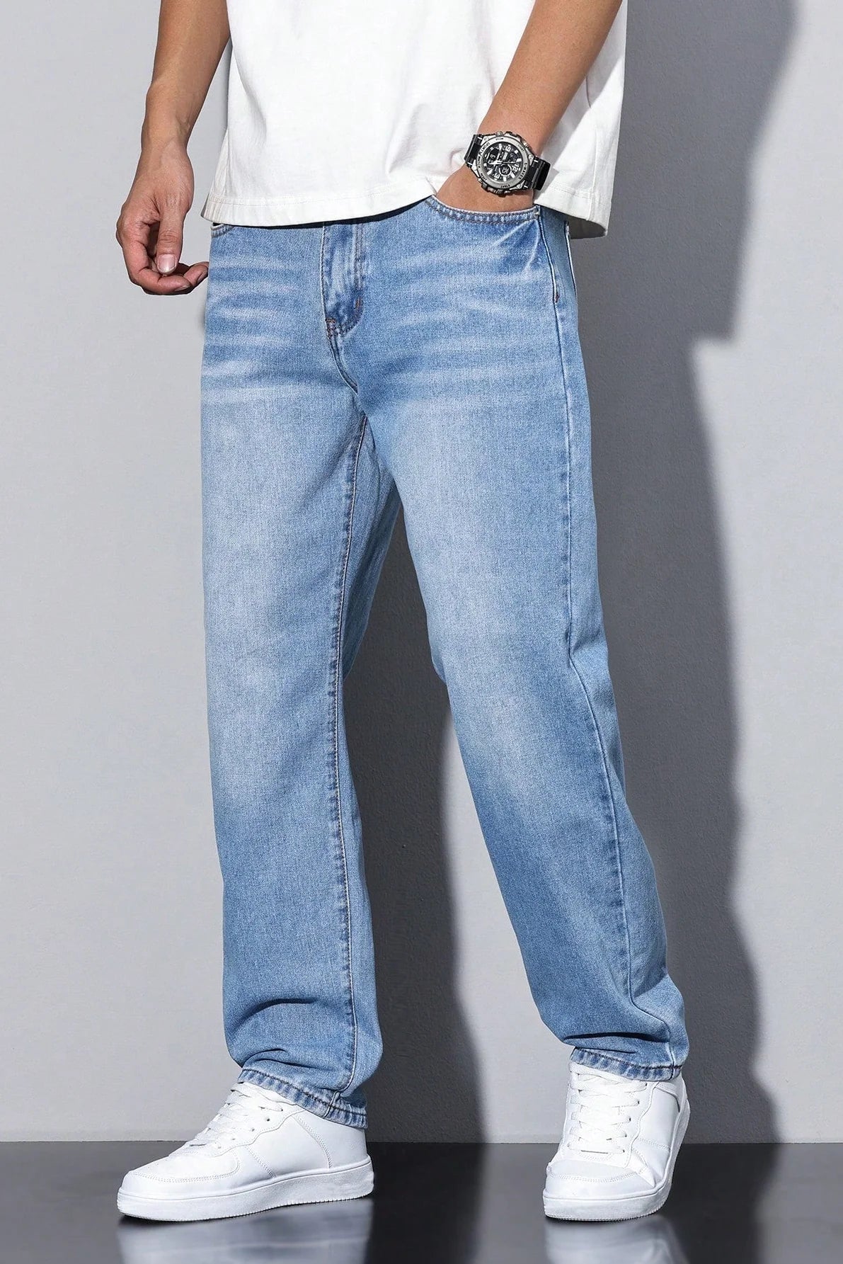 Full-length view of men's washed grey straight leg jeans with classic denim styling
