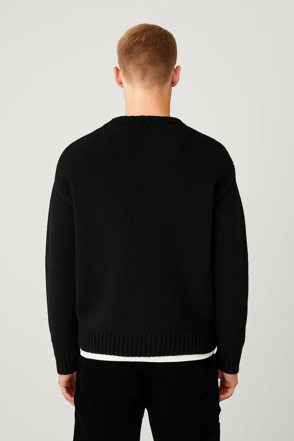 Close-up view of men's ribbed jumper showing textured knit pattern and crew neckline detail