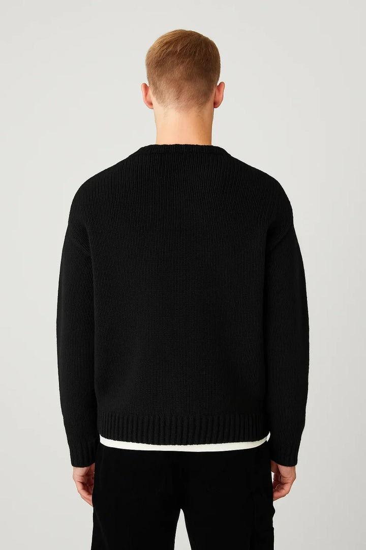 Close-up view of men's ribbed jumper showing textured knit pattern and crew neckline detail