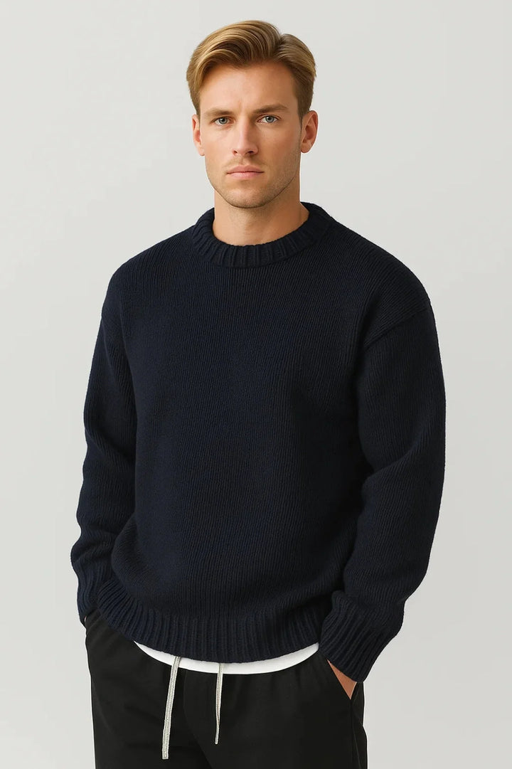 Detail shot of ribbed jumper texture and crew neck collar construction for men