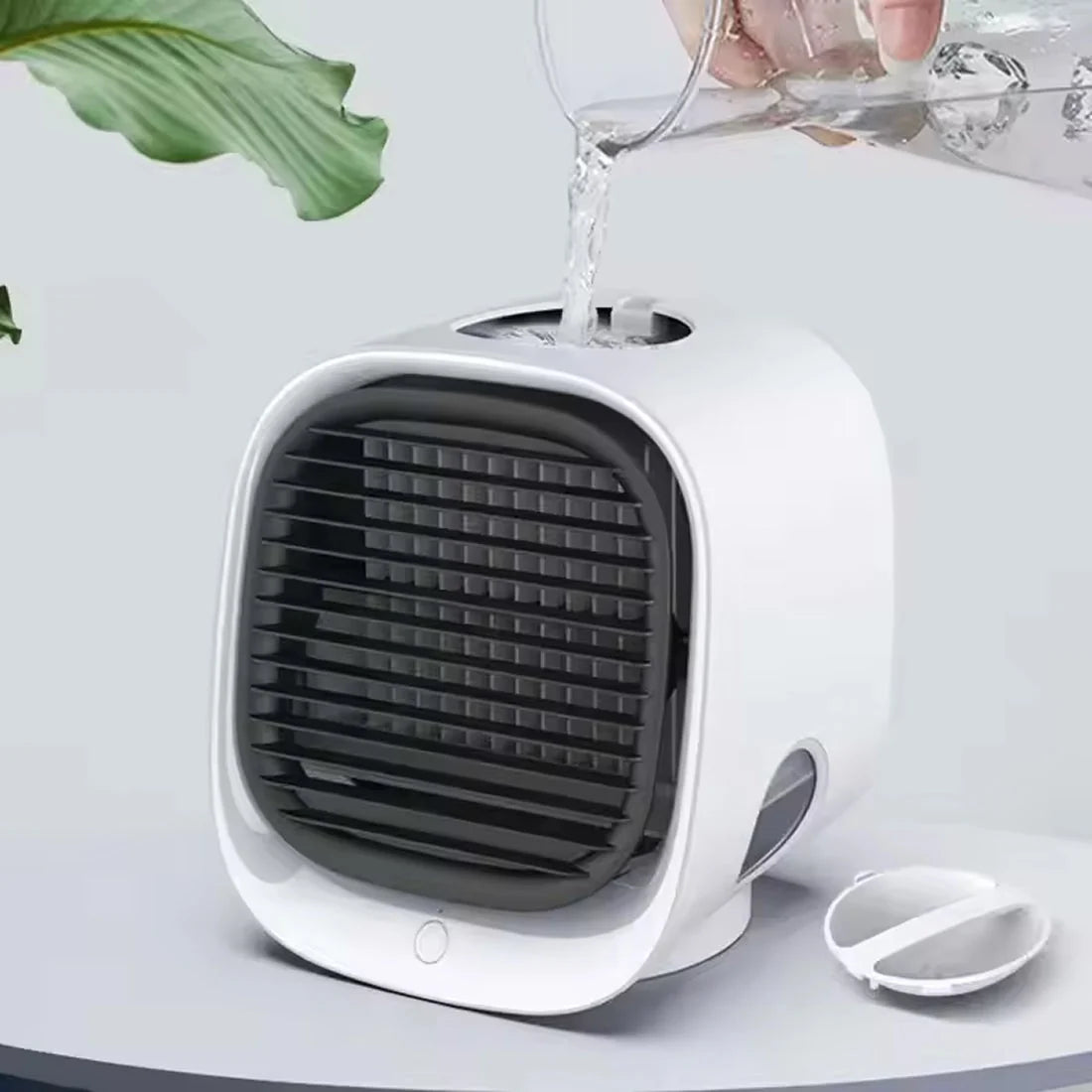 Desktop air cooler with rounded square housing and front-facing grille for quiet personal cooling during warm weather