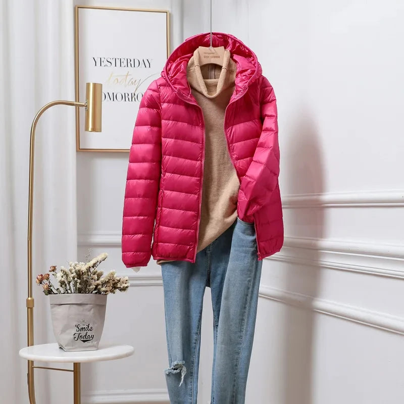 Cropped hooded puffer jacket sleeve detail showing lightweight insulated construction
