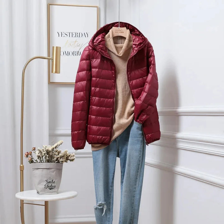 Women's puffer jacket hood close-up demonstrating fitted design and wind protection