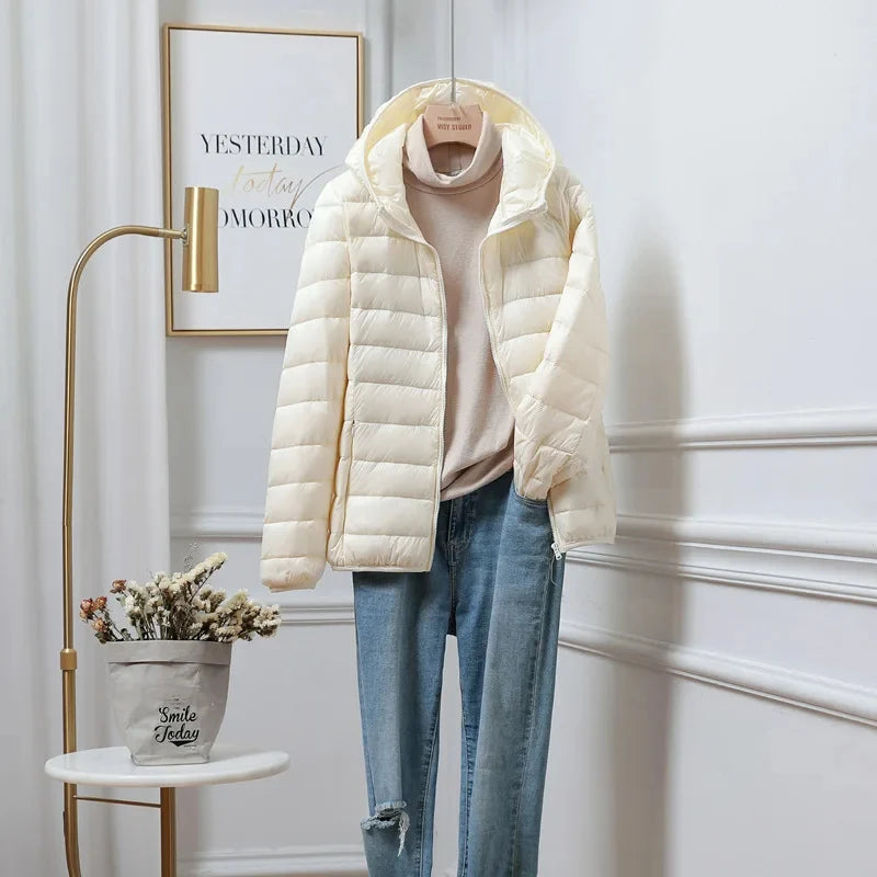 Women's lightweight puffer jacket side view highlighting hip length cropped fit