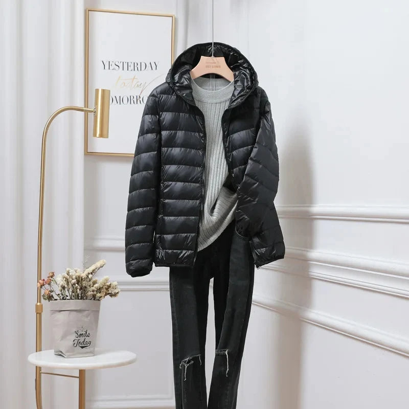 Hooded puffer jacket detail showing fitted hood and slim silhouette construction