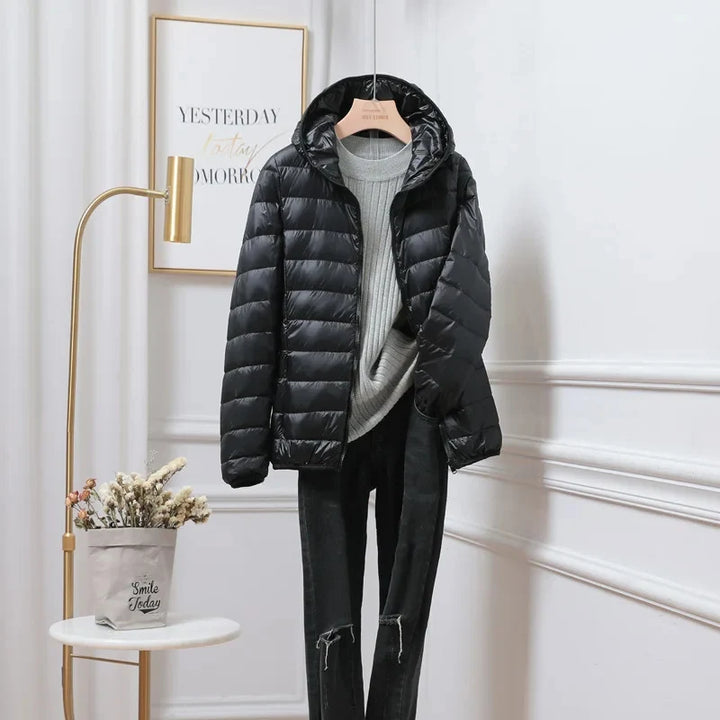 Hooded puffer jacket detail showing fitted hood and slim silhouette construction