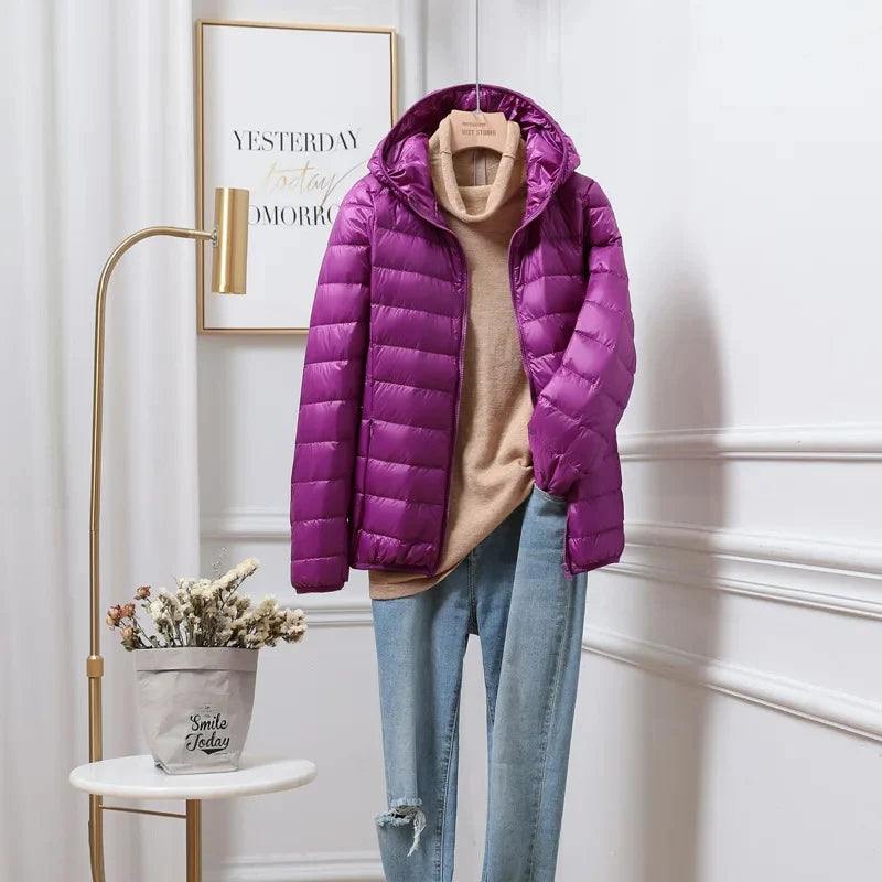 Women's hooded puffer jacket fabric detail highlighting soft matte finish quilting
