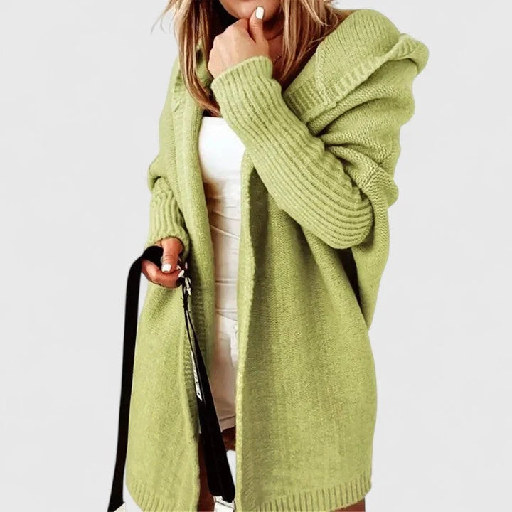 Detail of hooded cardigan showing attached hood and oversized silhouette