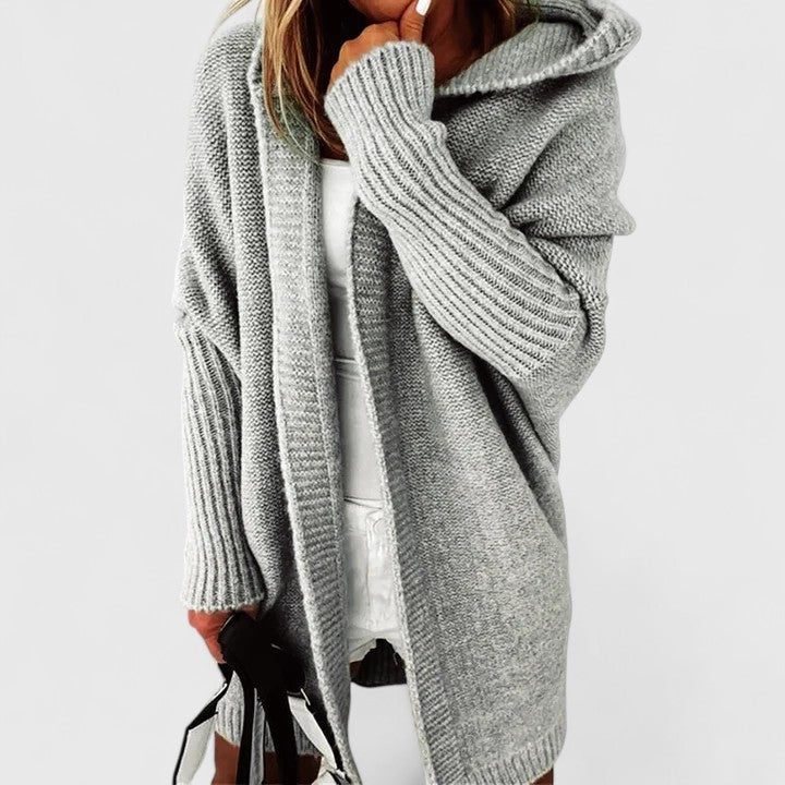 Full-length view of women's oversized hooded cardigan in coral knit fabric