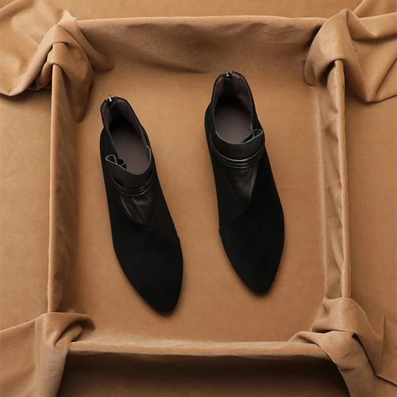 Close-up of pointed toe and smooth suede finish on ankle boots