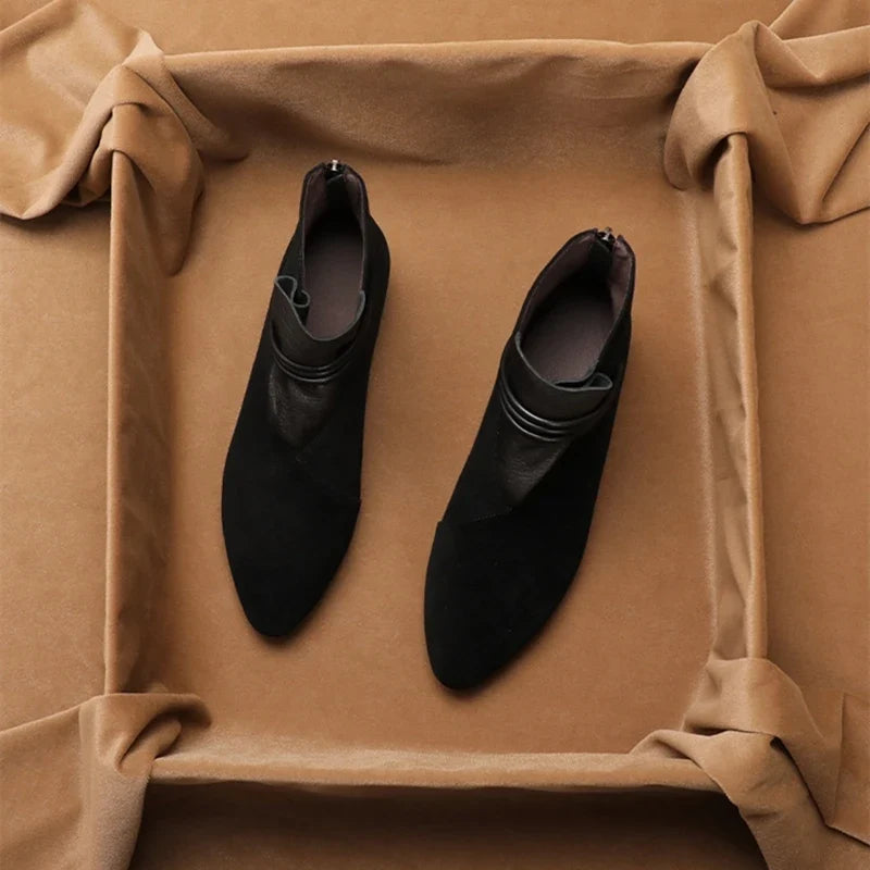 Overhead view of suede ankle boots displaying pointed-toe silhouette