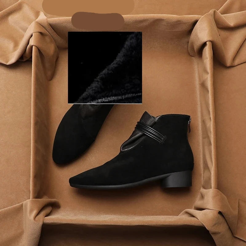 Close-up of low block heel and sole construction on ankle boots