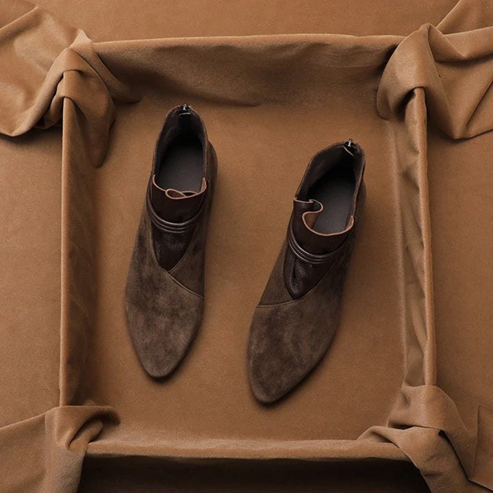 Detail shot of suede ankle boots showing cushioned insole and interior lining