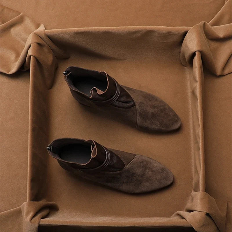 Top view of women's ankle boots showing pointed-toe shape and suede texture