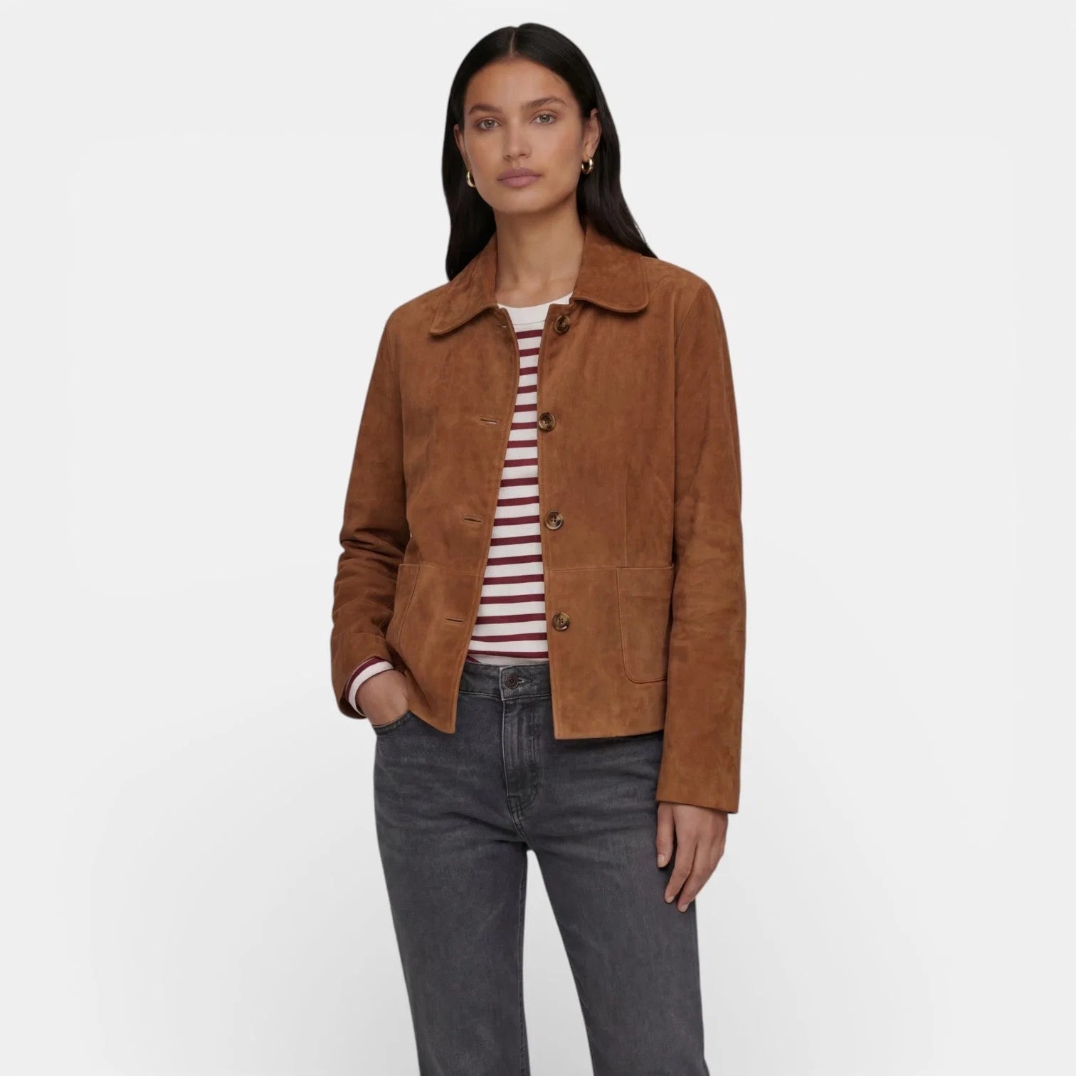 Women's suede jacket in brown with relaxed fit, collared neckline, and button-front closure styled with striped top