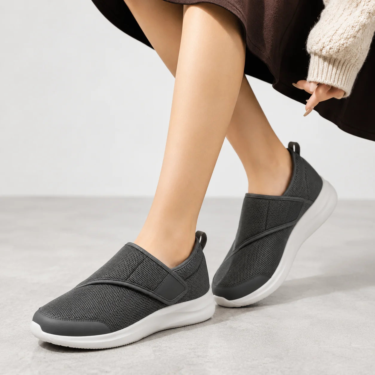 Side view of wide fit trainers with cushioned white sole and adjustable strap design for women