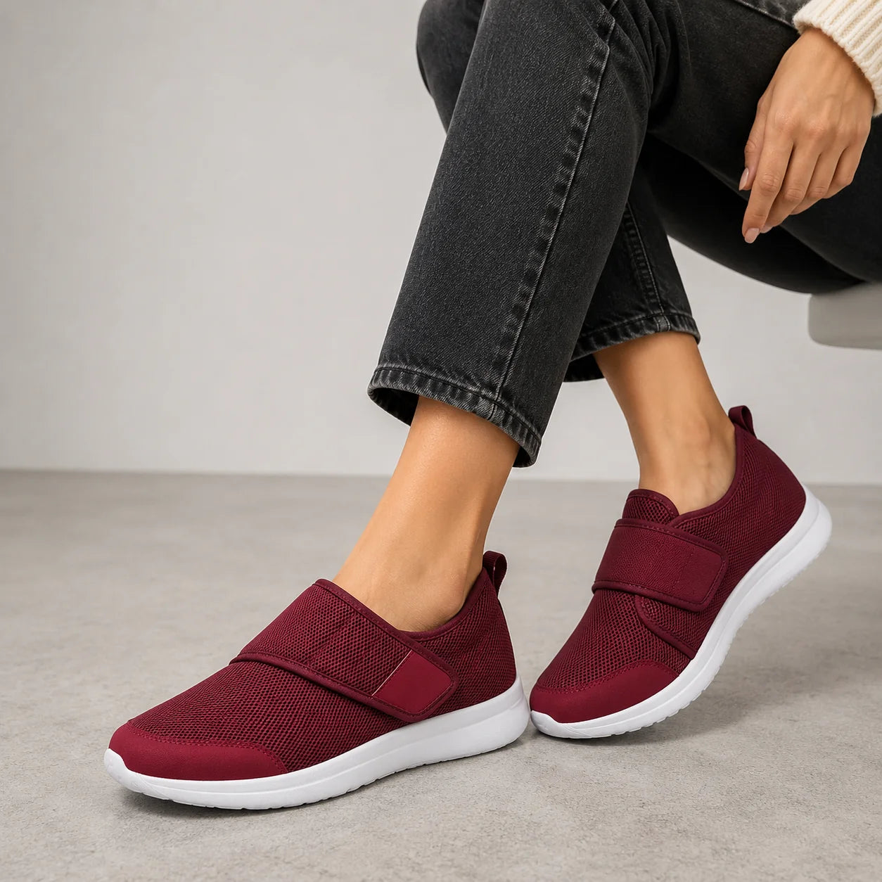 Detailed view of women's wide fit trainers featuring breathable perforated upper and secure hook-and-loop fastening