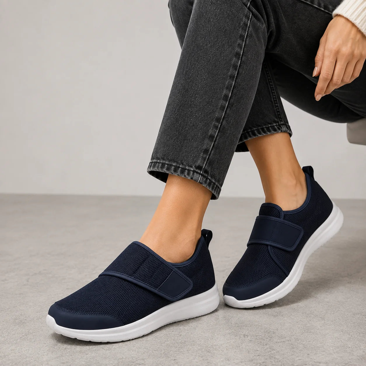 Full view of grey wide fit trainers with white contrast sole and adjustable strap for everyday comfort