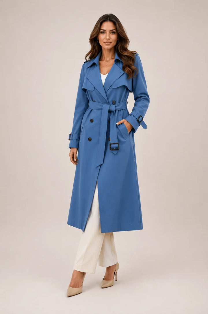 Tailored trench coat with adjustable belt and buckle cuffs worn with matching trousers