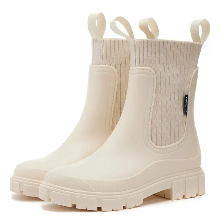 Detail of women's Chelsea rain boot sole showing deep tread pattern for wet weather grip