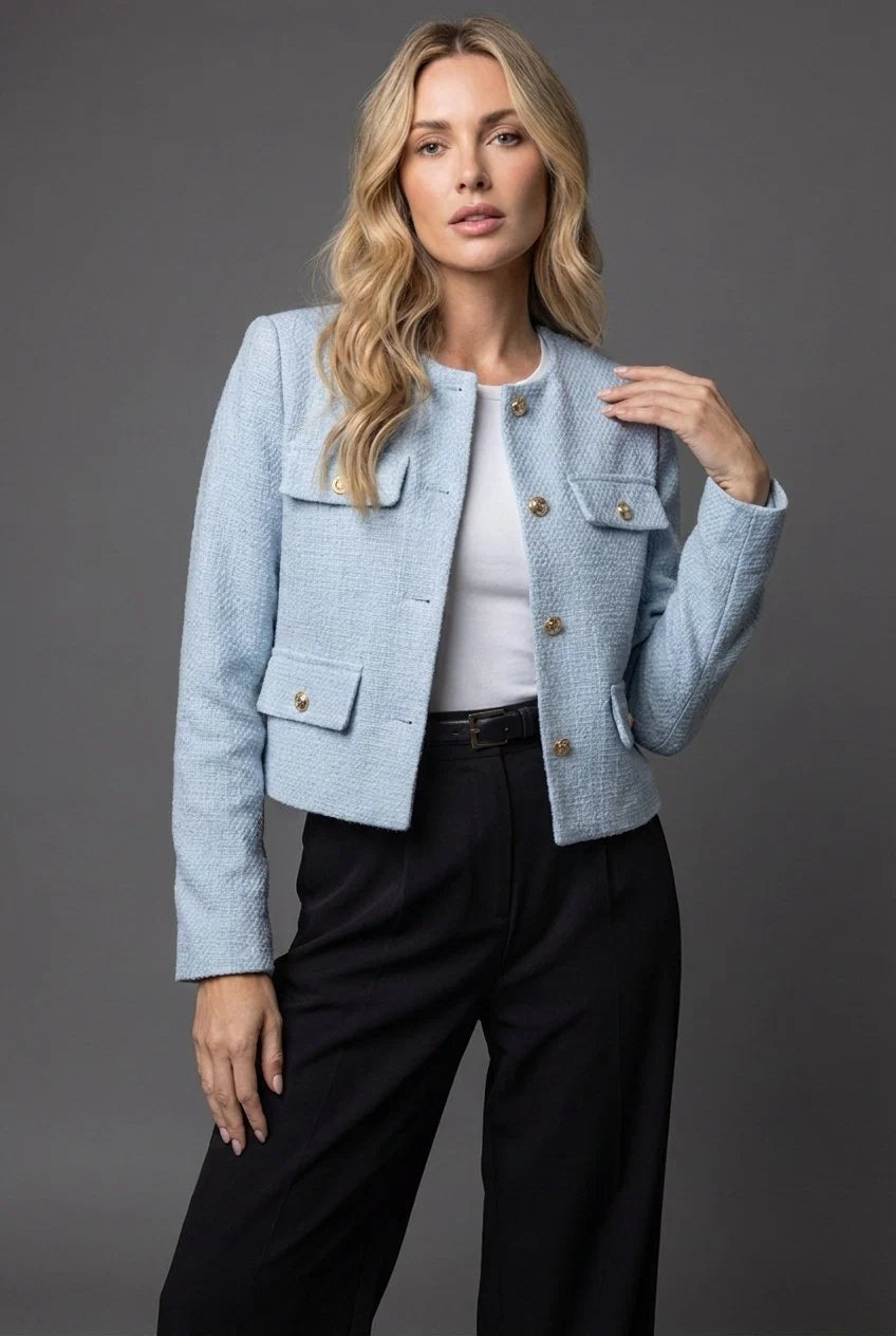 Women's cropped tweed blazer in light blue with gold button closure and collarless neckline