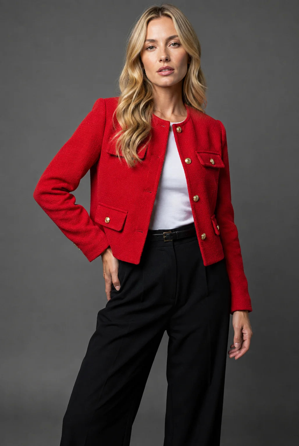 Cropped tweed jacket styled over white top with black trousers