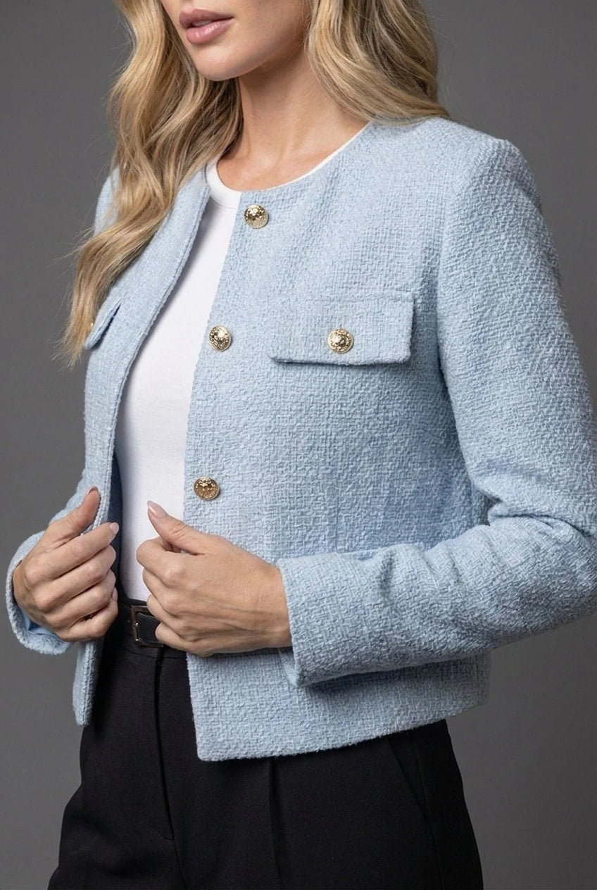 Light blue textured tweed blazer styled with black trousers for smart casual look