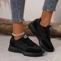 Women's cushioned trainers in black with slip-resistant outsole and lace-up front closure
