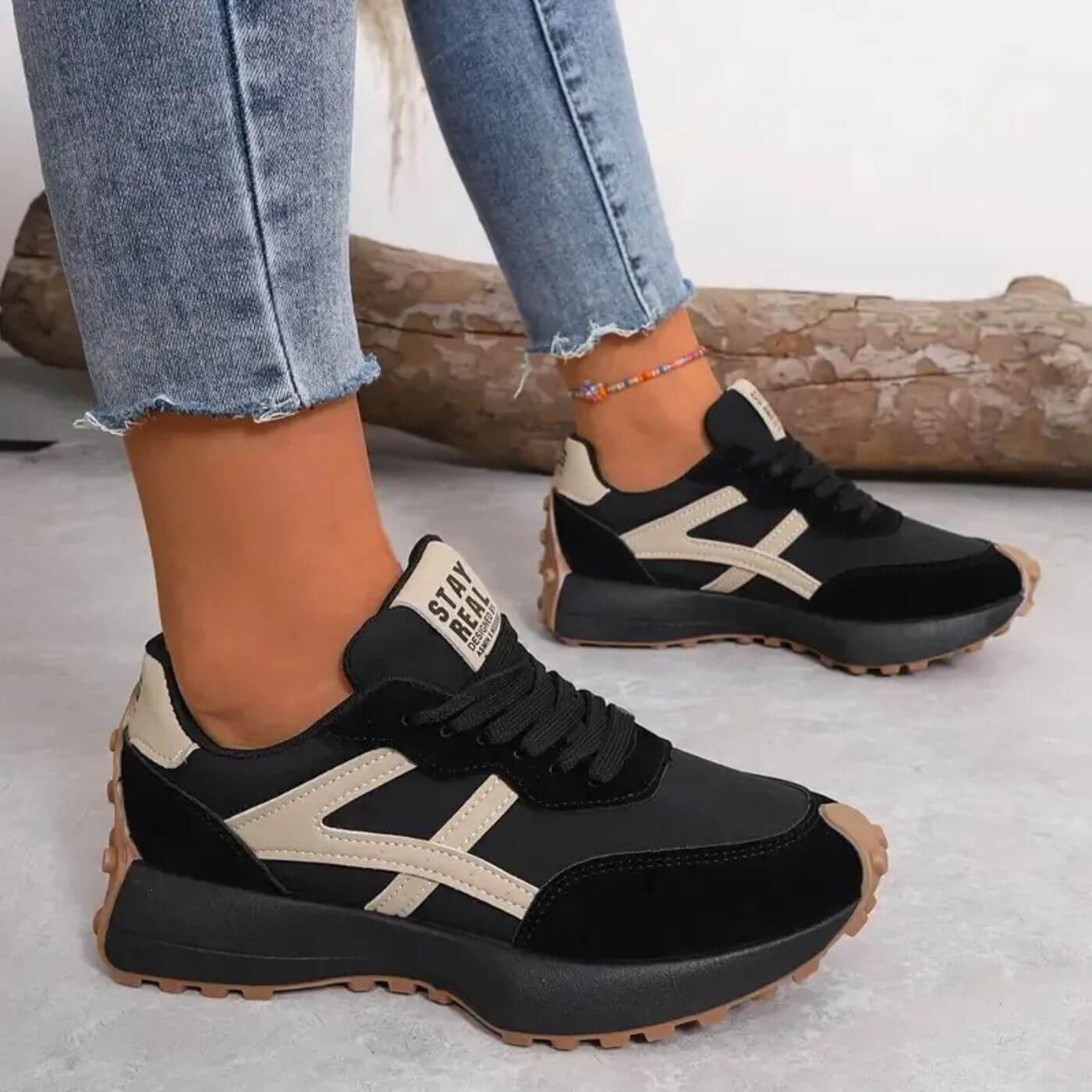 Side view of women's cushioned trainers showing panelled construction and padded ankle collar