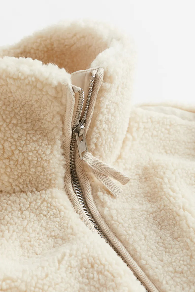 Close-up view of the plush teddy fleece texture and relaxed fit of the women's zip-up jacket