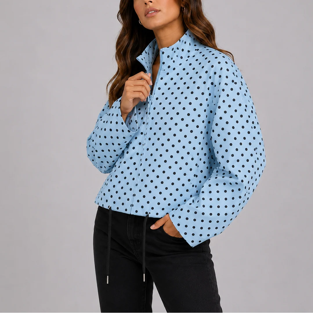 Close-up view of polka dot bomber jacket showing white dot pattern and zip-up front detail
