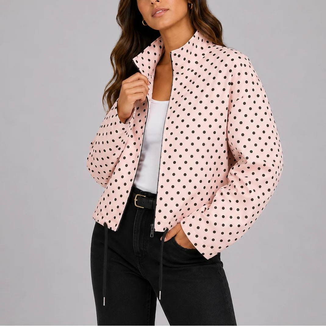 Woman styling navy polka dot bomber jacket with black jeans for casual everyday look